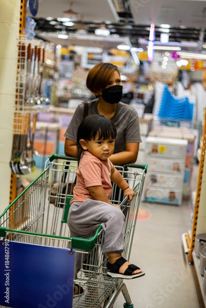 Obraz Mom And Child Shop With Cart in Market