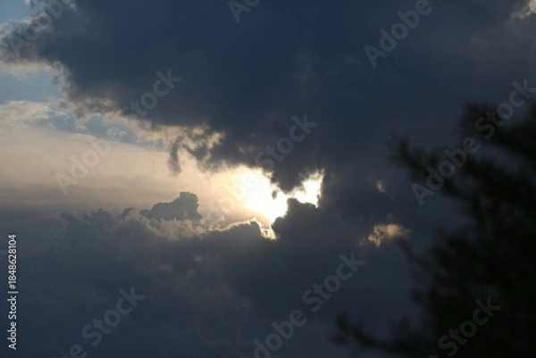 Obraz Sunset Through Clouds Over A Mountain Range