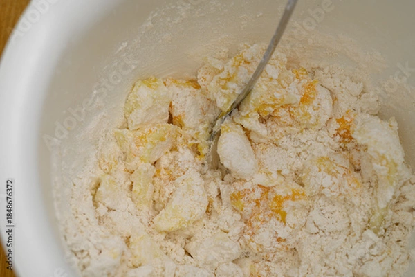Obraz Mix flour with sugar, butter and egg, preparing the dough