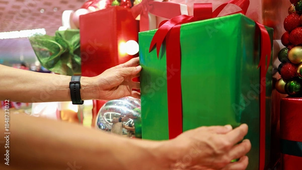 Obraz Man hand with Choosing the Perfect Gift