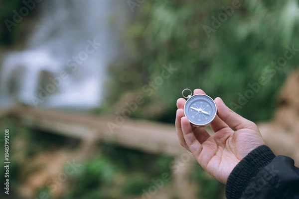 Obraz Hand holding compass finding direction in nature
