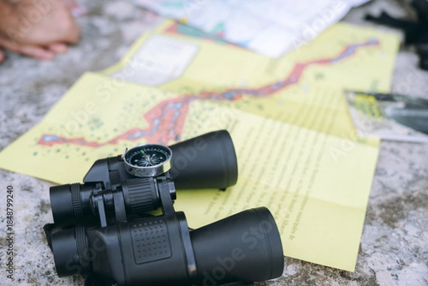 Obraz Binoculars and compass on map planning exploration