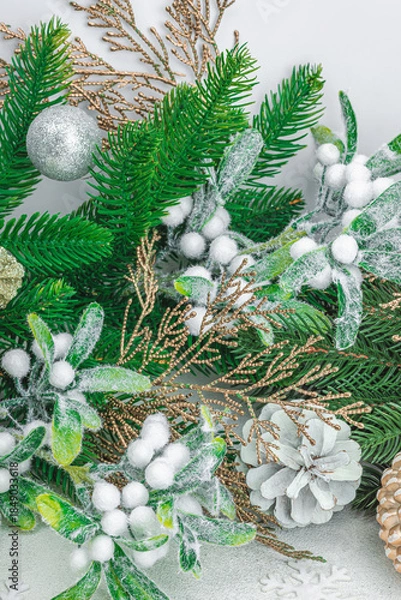 Obraz Traditional New Year composition. Festive decor, snowy Christmas tree branches, balls, flowers