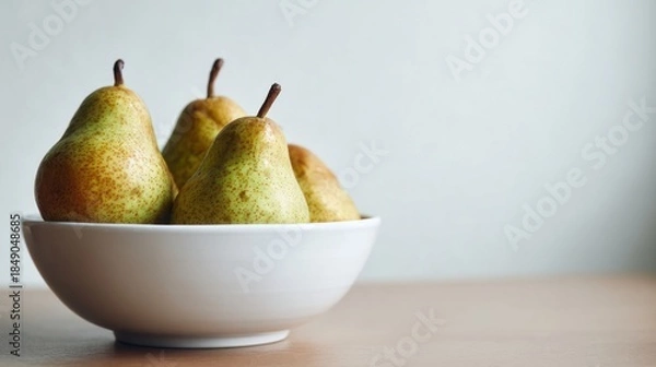 Obraz Fresh pears in a white bowl on table