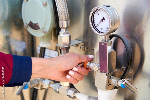 Fototapeta Fragments of gas processing equipment. Natural-gas processing plants purify raw natural gas by removing common contaminants such as water, carbon dioxide and hydrogen sulfide.