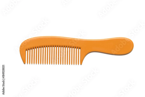 Obraz Orange comb is placed on a white background.