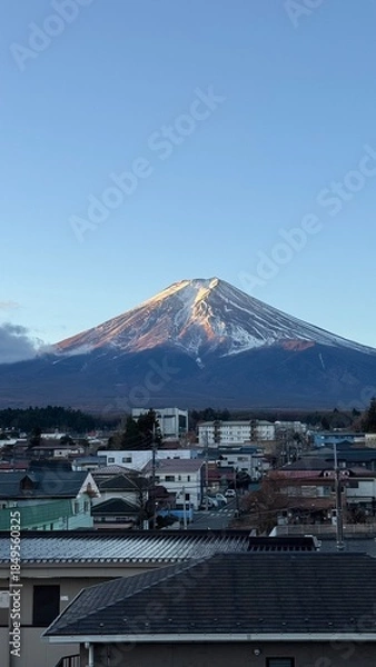 Fototapeta Mount Fuji, Japan, with a village in the foreground.
