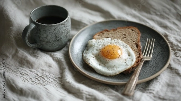 Obraz Simple Breakfast with Fried Egg and Coffee on Rustic Linen Background