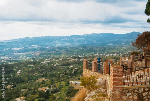 Fototapeta View point in the park of Mijas, a blue coin telescope and a beautiful panoramic aerial view to Mediterranean sea and surroundings of Fuengirola town on winter cloudy day, Andalusia, Spain.