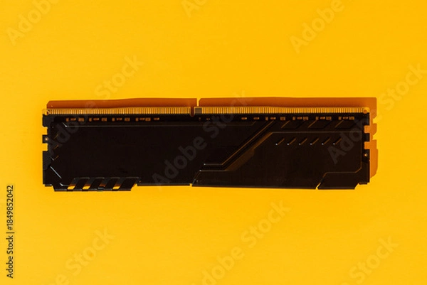 Obraz Single black RAM memory module on yellow background. High quality photo