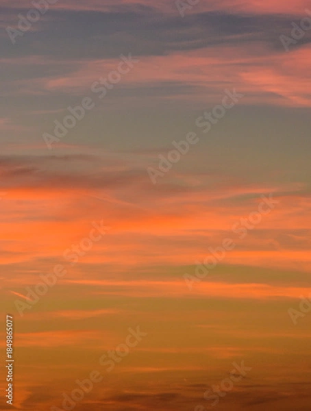 Obraz Dramatic yet calm sunset sky with light clouds and gradients