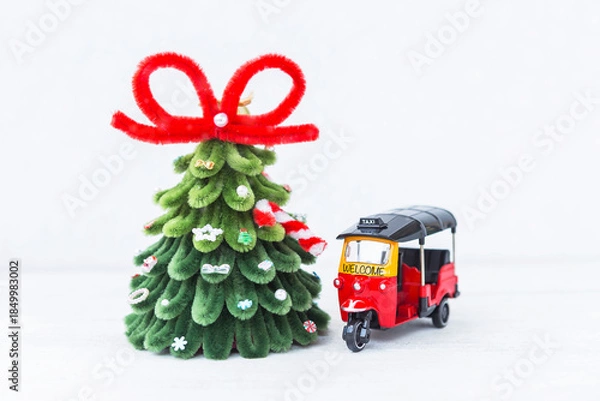 Obraz Tuk Tuk taxi and Christmas tree on white background, welcome holiday to Thailand, travel to Asia, Christmas card background idea