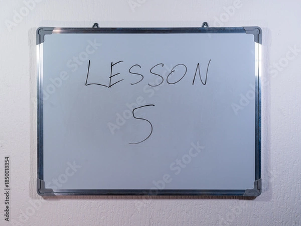 Obraz Whiteboard showing LESSON message representing knowledge transfer, training and skill development