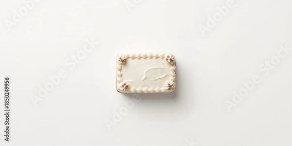 Obraz Top-down view of a rectangular cake on a plain white surface for presentation purposes