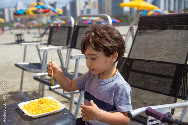 Obraz 4 year old boy eating boiled corn