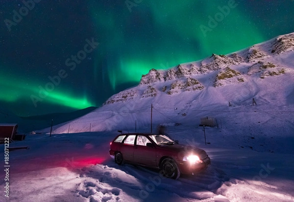 Fototapeta The polar arctic Northern lights aurora borealis sky star in Norway Svalbard in Longyearbyen city the moon mountains