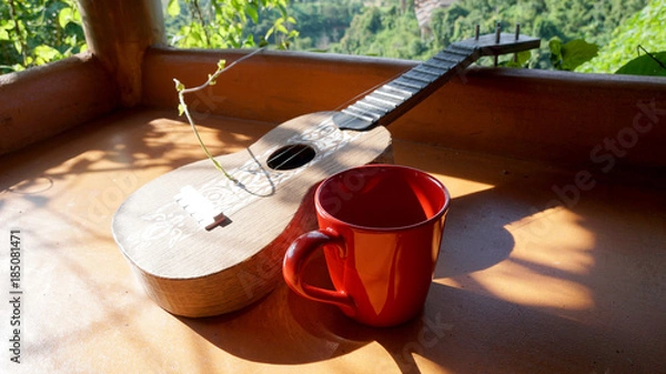 Obraz Ukulele and red coffee cup