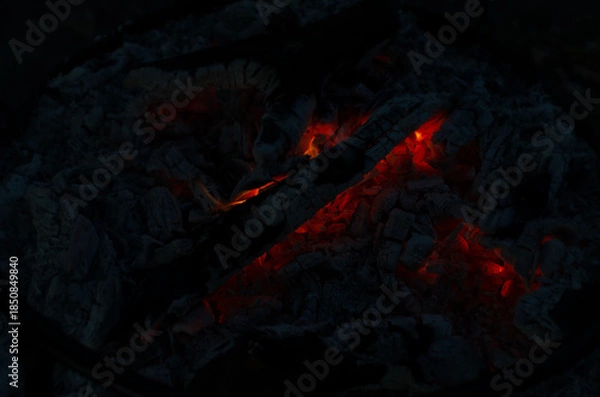 Obraz Glowing Embers in Cold Night Ashes Create Warm Light and Subtle Fire Spots in a Fire Pit