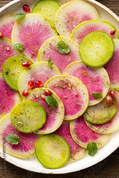 Obraz Close  up of sliced winter pink radishes on plate food texture
