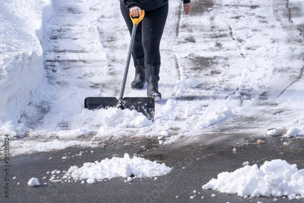 Fototapeta shoveling the snow on driveway