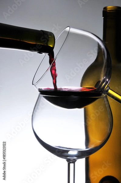 Fototapeta Wine Pour Stacked Glasses and Bottle