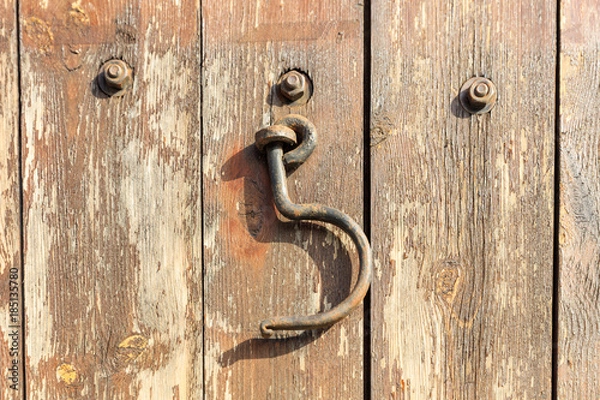Obraz Rusty hook hanging on an wooden door. Close up view.