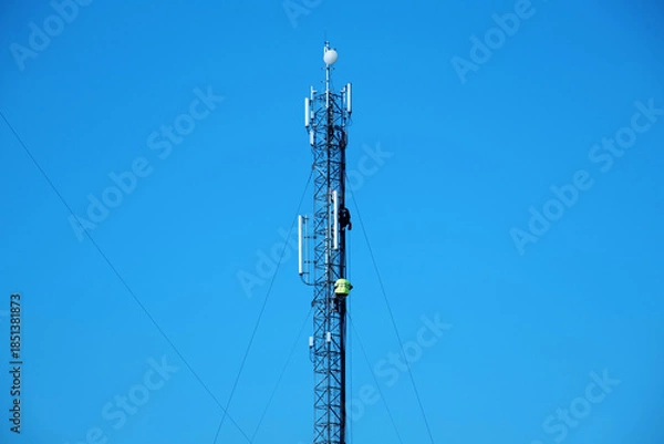 Fototapeta Maintenance staff at the work. High-altitude work. Workers repair cell tower