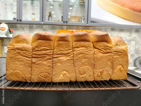 Fototapeta Large Bread loaf. Crispy Baked golden color