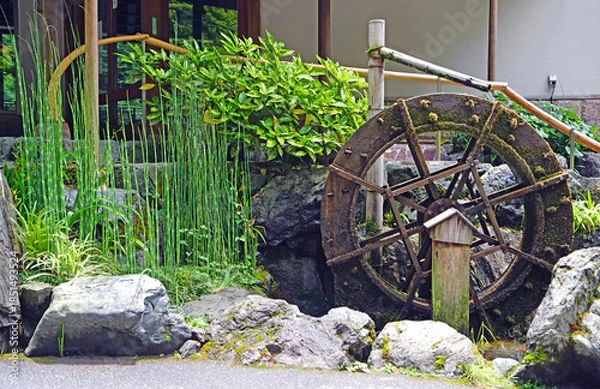 Obraz Rustic water wheel with moss and bamboo in a serene Japanese garden setting