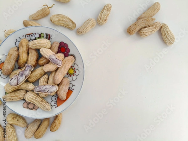Fototapeta Top view of Boiled peanuts served on a plate against. peanuts on a white background. with copy space