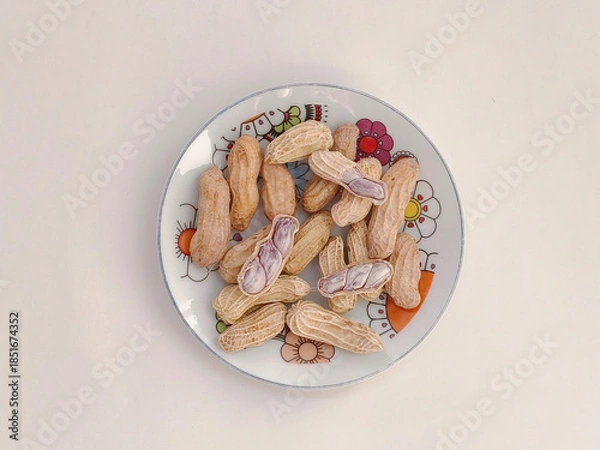 Obraz Top view of Boiled peanuts served on a plate on a white background.