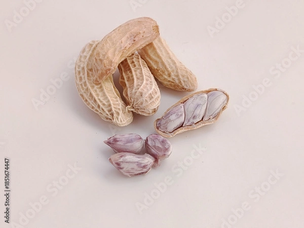 Obraz Boiled peanuts, both shelled and unshelled, on a white background.