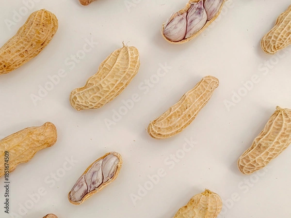 Fototapeta Close up, top view of peanuts against a white background as a pattern.