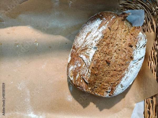 Fototapeta Sourdough bread in a basket with copy space.