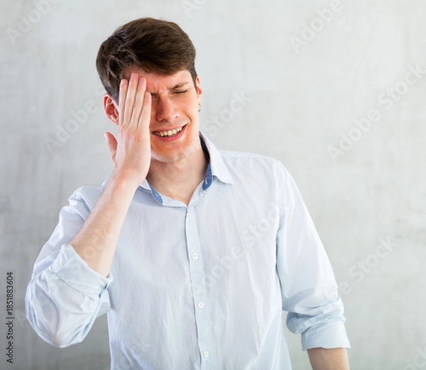 Obraz Young man experiencing acute headache in living room