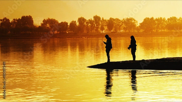 Obraz Two People Standing On Pier At Sunset