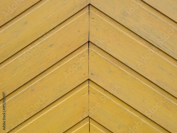 Fototapeta Wooden herringbone background. A fragment of an old wooden door. Old vintage diagonal planked wooden texture