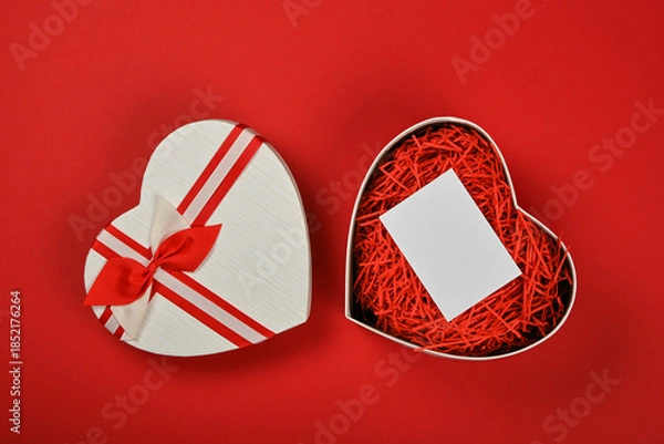 Obraz Open heart shaped gift box over red