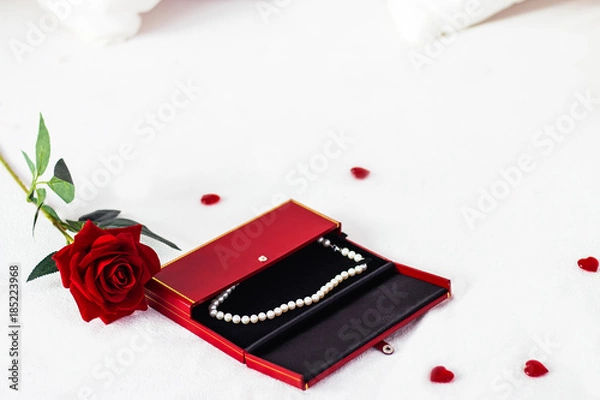 Obraz Valentines day surprise at morning on the white bed for her. Red heart background with rose with box. copy space