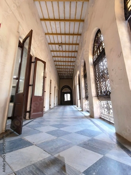 Obraz Long Hallway with Checkered Floor and Arched Windows