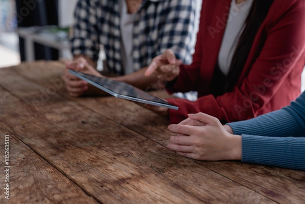 Fototapeta Business team collaborating on digital tablet for strategy