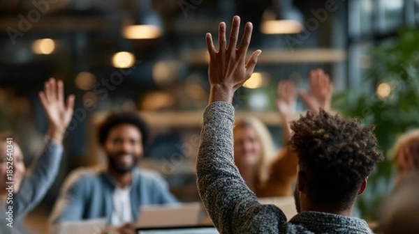 Fototapeta Group discussion fostering collaboration in a modern office setting with engaged participants raising hands