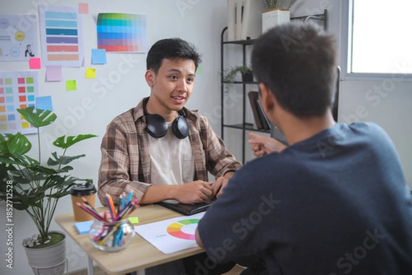 Obraz Graphic Designers Collaborating on Logo Concepts, Selecting Colors