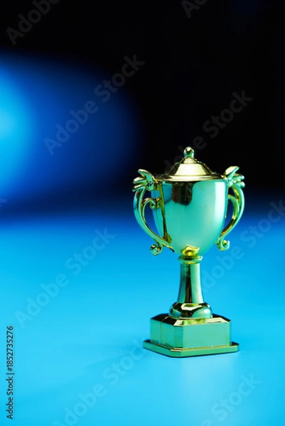 Obraz small trophy against blue background.