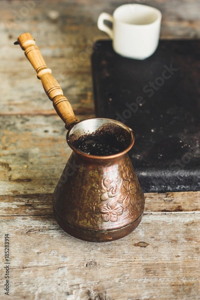 Fototapeta make coffee. Turka with coffee on a wooden table