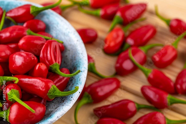 Obraz Vibrant red jalapeno pepper on a white background with space for text, ideal for food and culinary concepts.Group of ripe red jalapeno peppers .