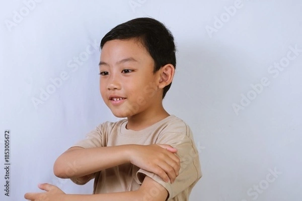 Obraz Asian Boy Portrait with Neutral Expression on White Background