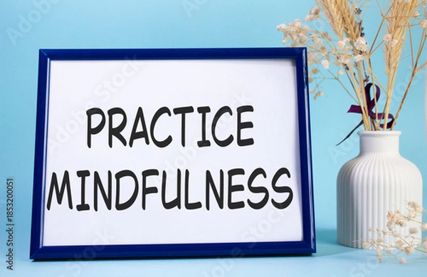 Obraz Mindfulness symbol. Concept words Practice Mindfulness on beautiful wooden picture frame. Beautiful light blue background with flower vase. Medical and Psychology concept. Copy space.