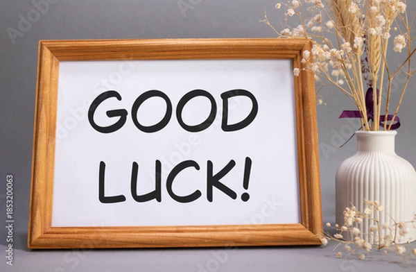 Obraz Good luck symbol. Concept words Good luck on beautiful wooden picture frame. Beautiful grey background with flower vase. Business and Good luck concept. Copy space.