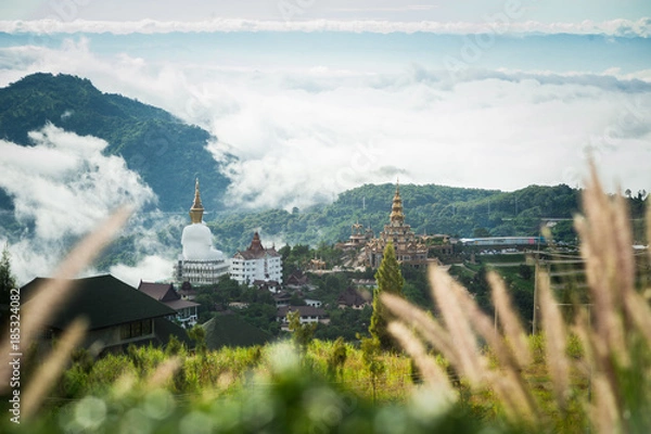 Fototapeta Big Buddha statue and pagoda on top of a hill with great views of the surrounding mountainous area at Wat Pha Sorn Kaew Temple in Khao Kho, Phetchabun Province, Thailand.